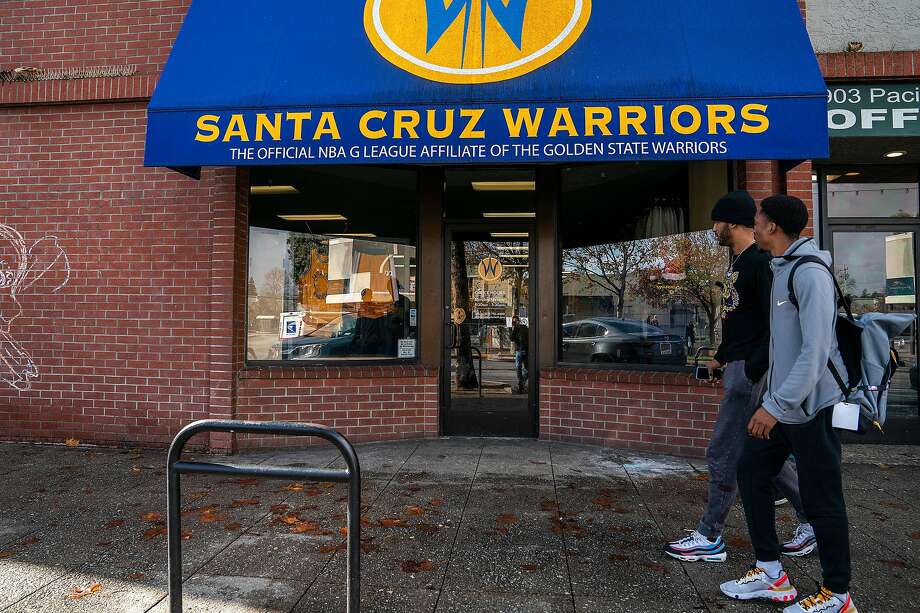 Santa Cruz Warriors guard Vander Blue, center right, walks with Warriors Basketball Operations and Team Player Development manager Mike Newton, right, past the Santa Cruz Warriors storefront after breakfast as they head back to the Kaiser Permanente Arena on Sunday, Dec. 8, 2019 in Santa Cruz, Calif. Photo: LiPo Ching / Special To The Chronicle
