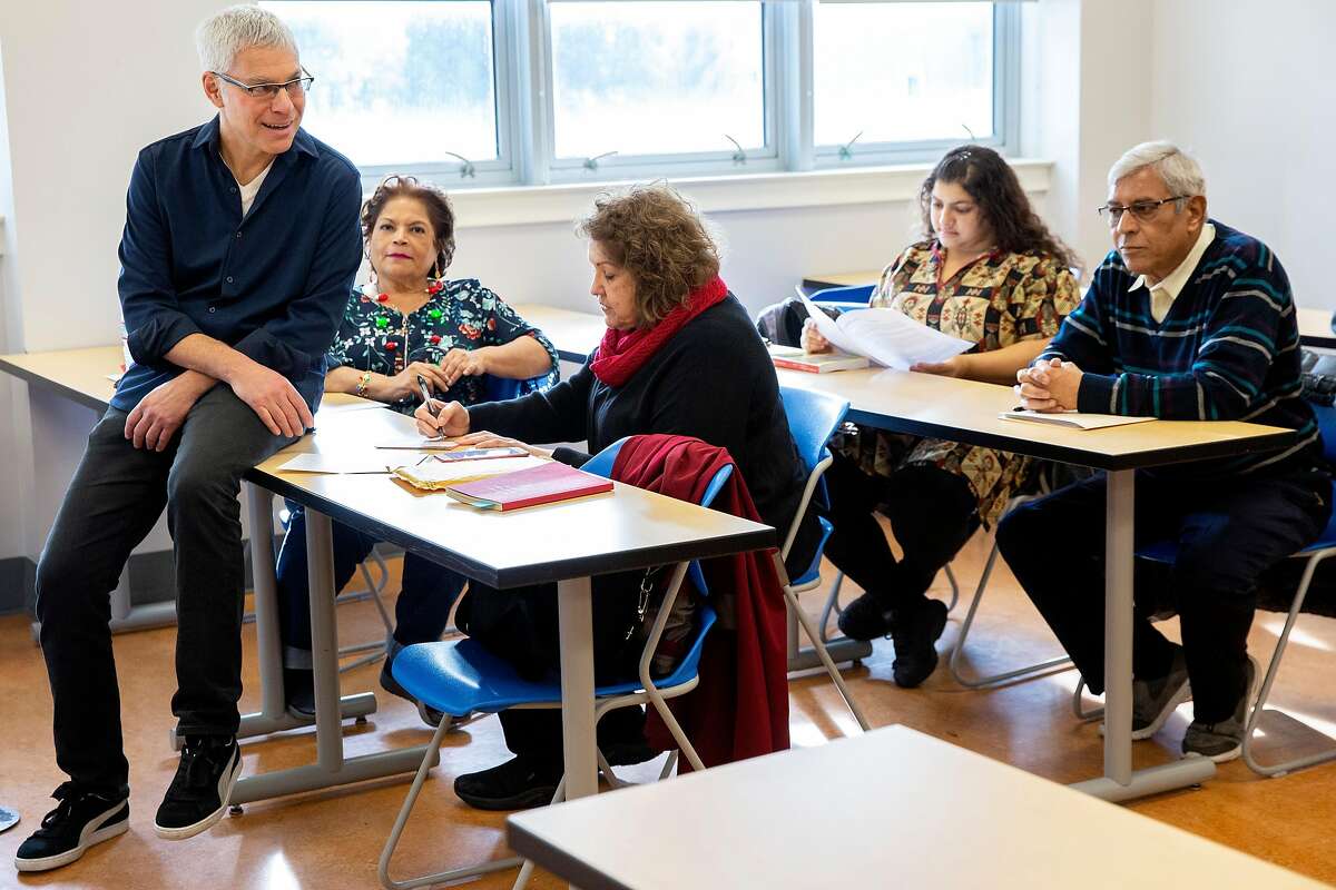 Steven Budd (left) with his students during a memoir writing course at City College of San Francisco?•s Mission Campus on Friday, Dec. 20, 2019, in San Francisco, Calif.