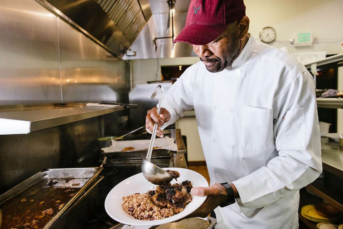 Owner Nigel Jones plates food in the kitchen of his Kingston 11 restaurant in Oakland, Calif, on Wednesday, May 15, 2019.