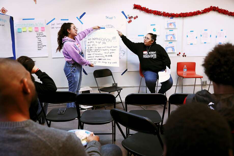 Itzel Estrada, left, and Krea Gomez, education director, Young Women's Freedom Center, present notes taken during a community mapping session at a town hall meeting at Excelsior Works in San Francisco, Calif., on Saturday, December 14, 2019. Photo: Yalonda M. James / The Chronicle