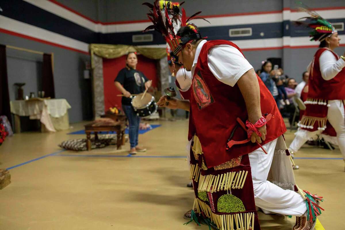 Matachines kneel to a doll of baby Jesus during a celebration of Las Posadas, Saturday, Dec. 7, 2019, in Conroe. The event is a Catholic tradition observed by Hispanic parishioners that commemorates the journey Joseph and Mary made from Nazareth to Bethlehem in search of refuge where Mary could give birth to Jesus.