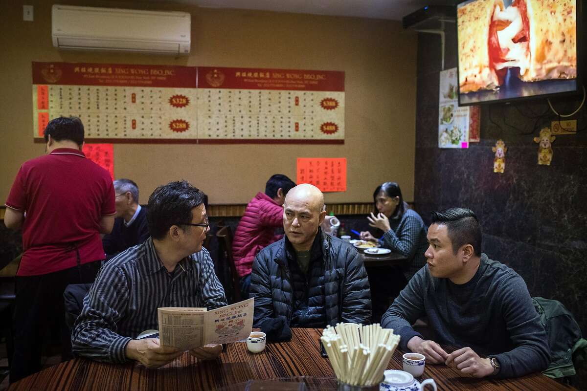 Taxi drivers, from left: Richard Chow, Wain Chin and Augustine Tang meet over lunch in New York's Chinatown on Dec. 10, 2019. An economic crisis has swept over New York City’s taxi industry, spreading financial ruin and personal despair, especially for owners of medallions, the permits that let people operate cabs. (Kholood Eid/The New York Times)