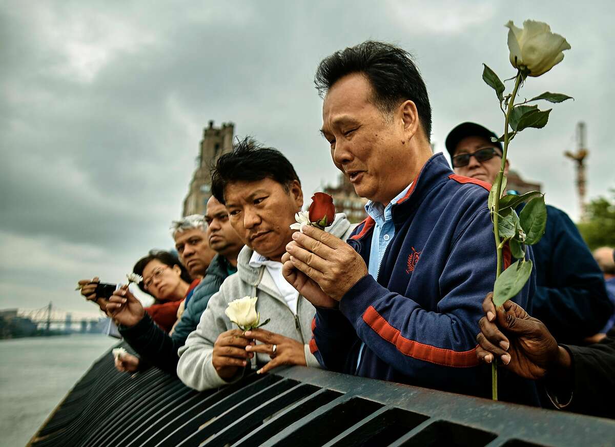 FILE -- Richard Chow holds a rose as he honors his brother, Kenny Chow, during a vigil in New York on May 27, 2018. The body of Kenny Chow, a taxi medallion owner despondent over debt, was found floating in the East River a few days before. (Andres Kudacki/The New York Times)