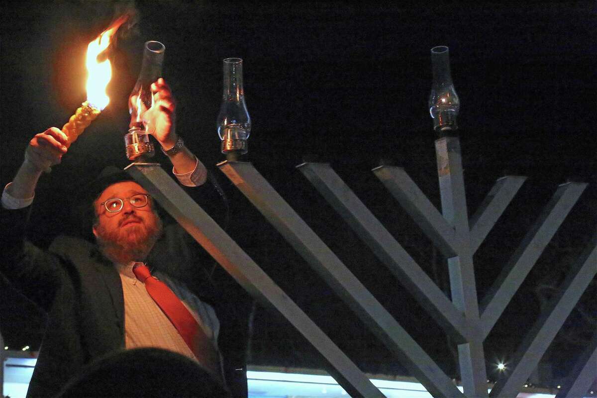 Rabbie Levi Stone lights the menorah at the Beth Israel Synagogue Chabad of Westport-Norwalk's menorah lighting on Dec. 23, 2019, in Westport.