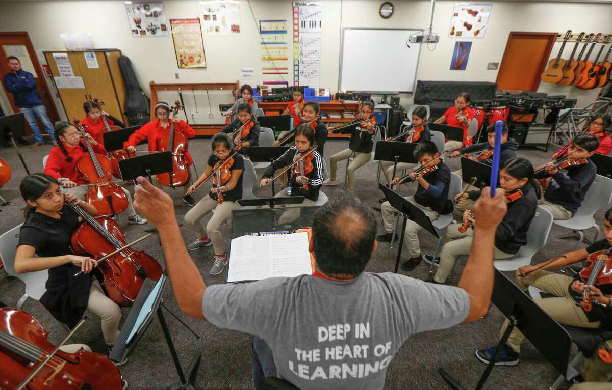 Mario Garcia conducts his orchestra at Pilgrim Academy, one of only nine area gold-ribbon middle schools — neighborhood schhols in which three-quarters of students are economically disadvantages and at least 60 percent pass STAAR tests.