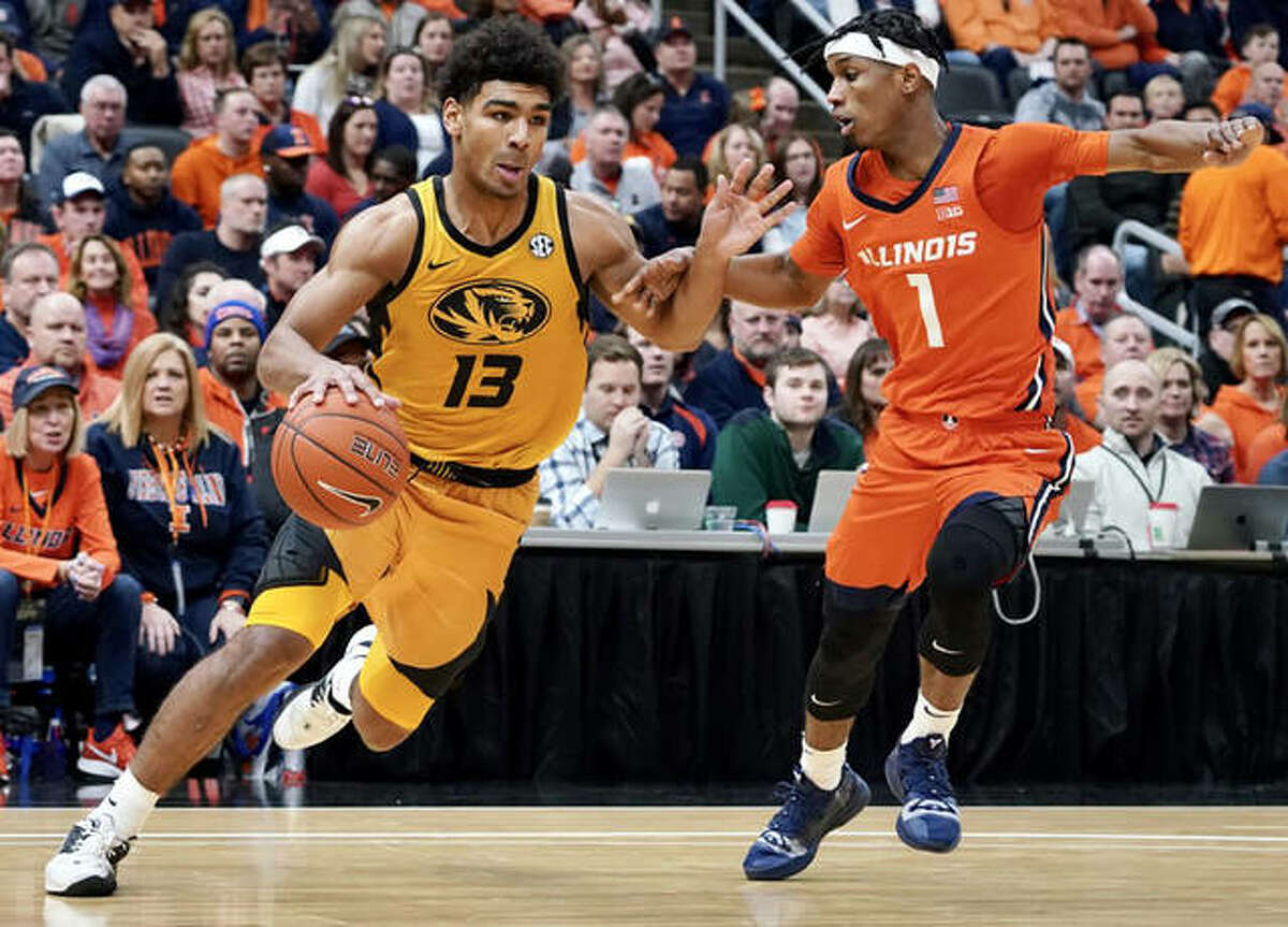 Missouri’s Mark Smith (left) drives past Illinois’ Trent Frazier during Saturday’s 39th annual Braggin’ Rights game at Enterprise Center in St. Louis.