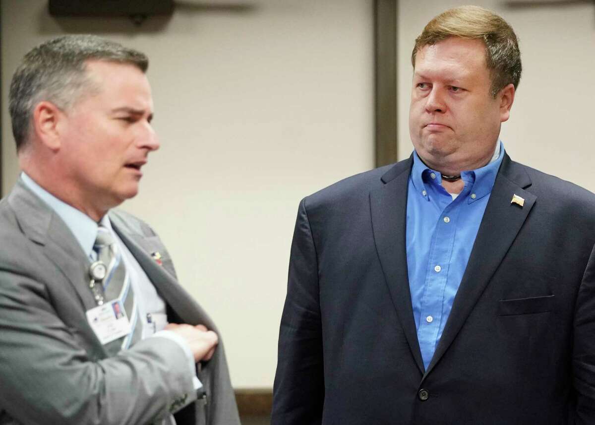 Former President Josh Flynn, left, and board member, Mike Wolfe, right, are shown at the Harris County Dept. of Education board meeting Wednesday, Feb. 27, 2019, in Houston.
