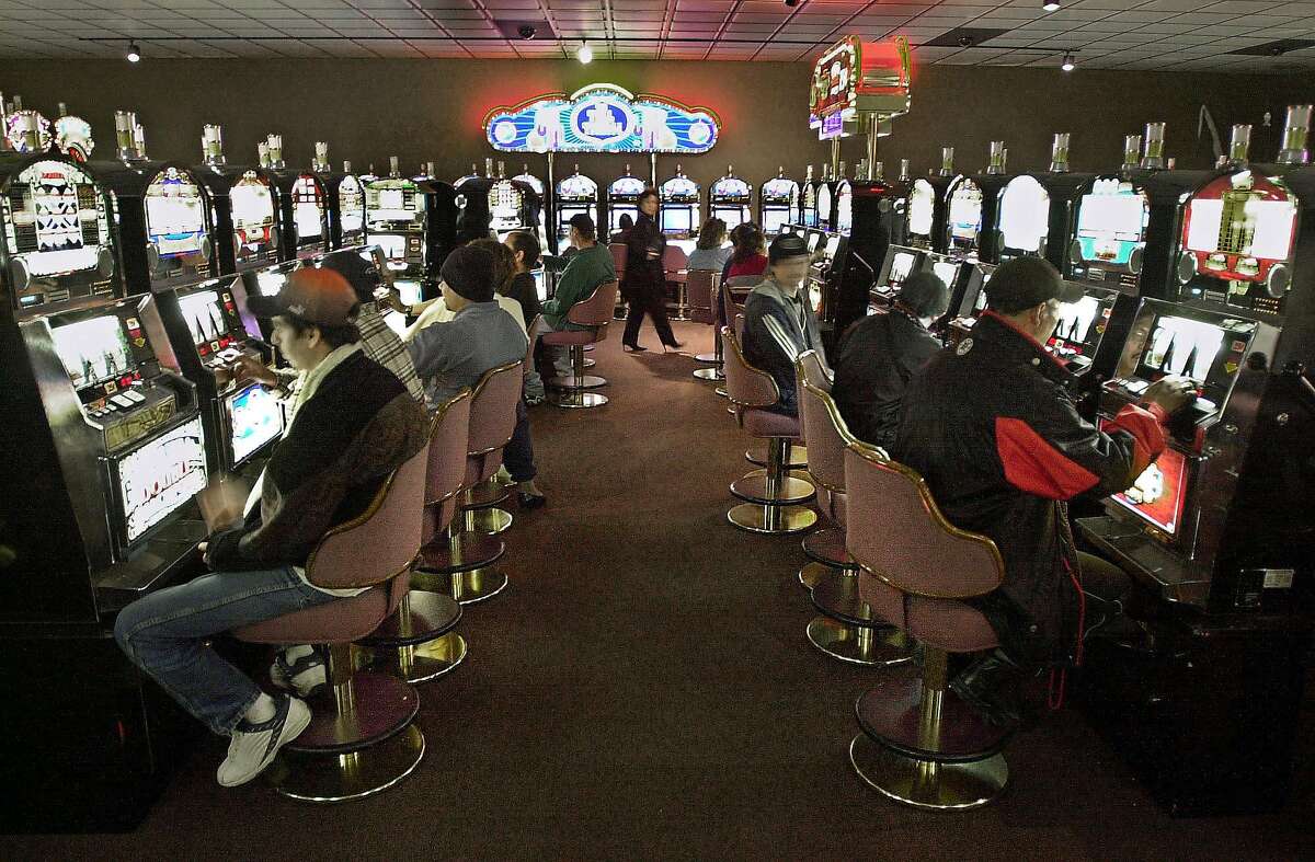 ** FILE ** Patrons play slots inside the Pomo Indian Tribe's River Rock Casino in Geyserville, Calif., Jan. 8, 2003. In an earlier sovereignty dispute, the state's attorney general had requested curtailed business hours for the casino, to address environmental concerns during expansion construction. Representatives of the 52 Affiliated Tribes of Northwest Indians gathered Monday Feb. 7, 2005 to discuss problems and priorities for the coming year from gaming to sovereignty. Tribal reprsentatives came from Oregon, Washington, Montana, Idaho, California, Nevada and Alaska. (AP Photo/Marcio Jose Sanchez, File)