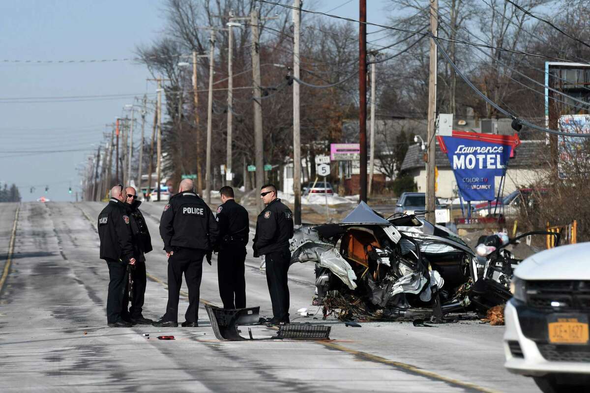 Colonie Police respond to the scene of fatal car crash near Lombard Street on Central Avenue on Wednesday morning, Dec. 25, 2019, in Colonie, N.Y. A silver Audi sedan was split in half after hitting a utility pole. One person was killed and three others are in critical condition, according to Colonie Police. (Will Waldron/Times Union)