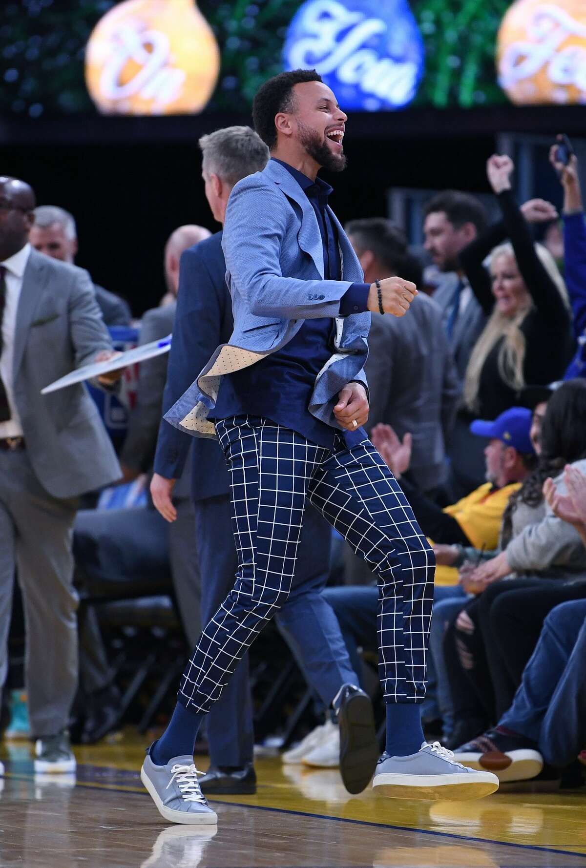 SAN FRANCISCO, CALIFORNIA - DECEMBER 25: Stephen Curry #30 of the Golden State Warriors celebrates off the bench after Draymond Green #23 made a three-point shot against the Houston Rockets during the second half of an NBA basketball game at Chase Center on December 25, 2019 in San Francisco, California. NOTE TO USER: User expressly acknowledges and agrees that, by downloading and or using this photograph, User is consenting to the terms and conditions of the Getty Images License Agreement. (Photo by Thearon W. Henderson/Getty Images)