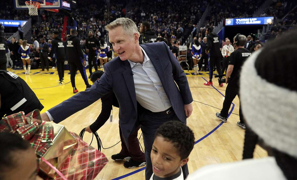 Warriors head coach Steve Kerr greets kids with the Season of Giving campaign that recieved gifts from players before the Golden State Warriors played the Houston Rockets at Chase Center in San Francisco, Calif., on Wednesday, December 25, 2019.