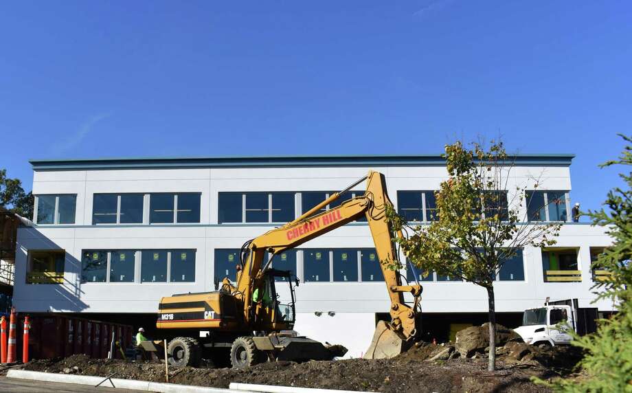 A construction crew works a Caterpillar backhoe Tuesday, Nov. 1 2016 at 500 Post Rd. East in Westport. Photo: Alexander Soule / Hearst Connecticut Media / Stamford Advocate