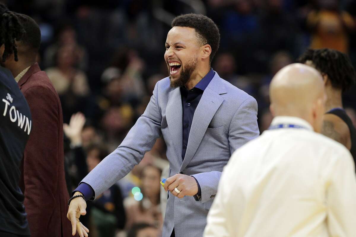 Stephen Curry (30) cheers from the bench in the second half as the Golden State Warriors played the Houston Rockets at Chase Center in San Francisco, Calif., on Wednesday, December 25, 2019.