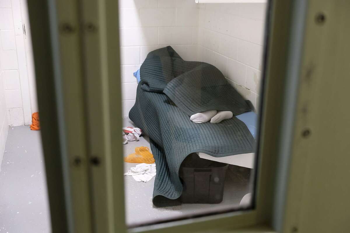An inmate is shown covered in a tear-resistant blanket sleeps at the Lake County Jail in Lakeport , Calif., on Tuesday, April 16, 2019. These blankets were one of the many changes and reforms made at the norther California jail after a 2015 suicide there resulted in a $2 million wrongful death settlement. (AP Photo/Eric Risberg)
