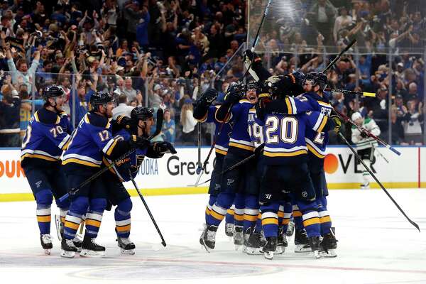 FILE - In this May 7, 2019, file photo, St. Louis Blues celebrate after defeating the Dallas Stars in double overtime in Game 7 of an NHL second-round hockey playoff series in St. Louis. (AP Photo/Jeff Roberson, File)