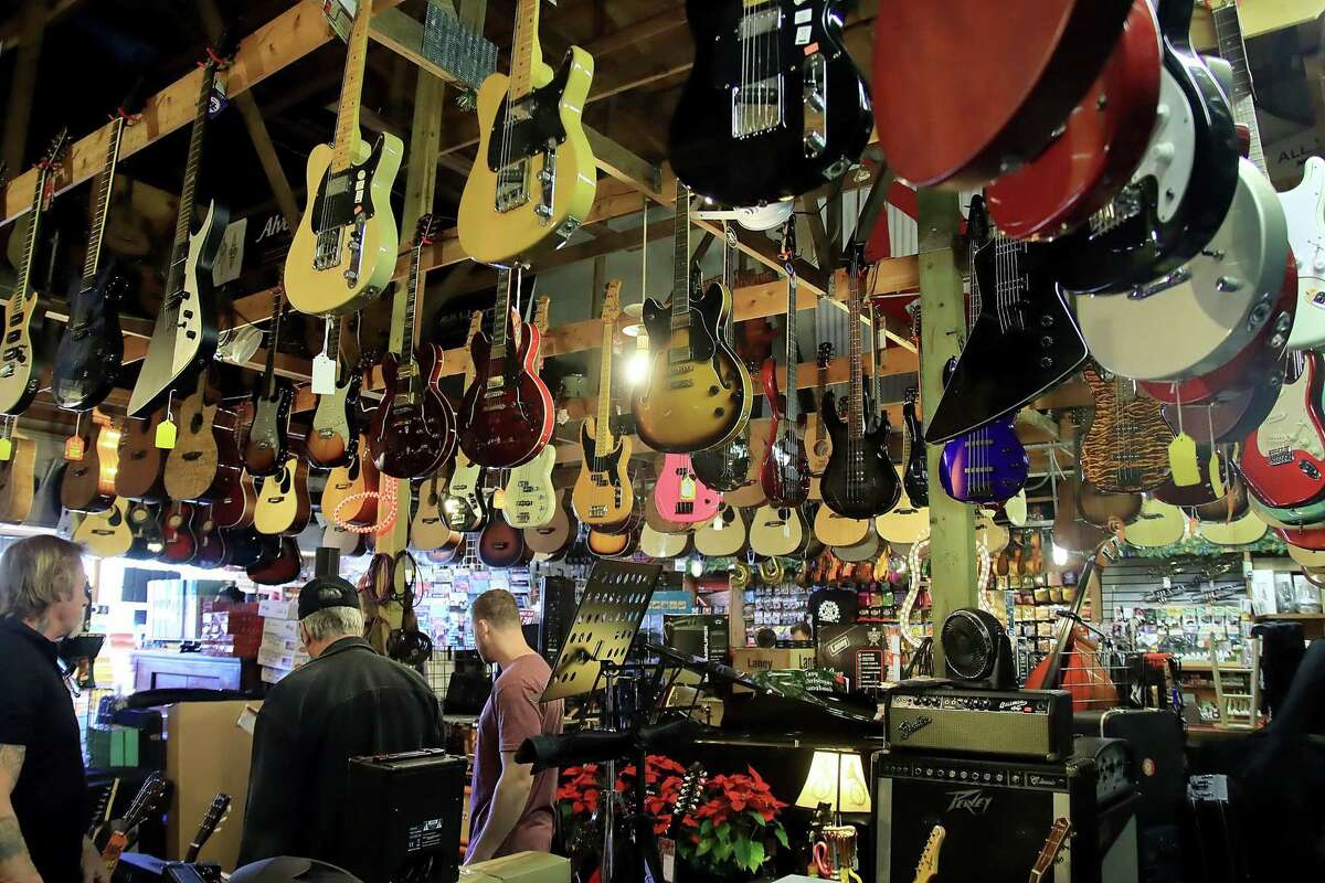Musical instruments and equipment fill every space on the floor and the rafters at the Music Factory in Pearland. “We’re a small business but filled to the gills,” manager Chase Townshend says.