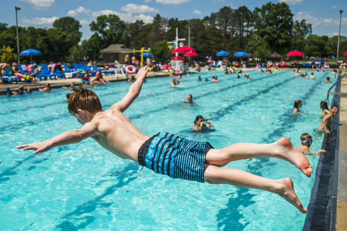 Tucker Spaulding, 9, jumps into the Plymouth Park Pool on Thursday, June 27, 2019 in Midland. (Katy Kildee/kkildee@mdn.net)