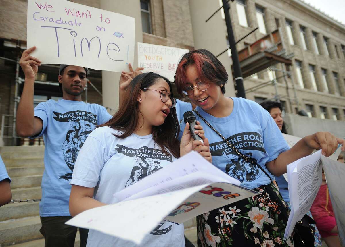 Tania Chapa, left, and Morgan Gonzalez, both 14 of Bridgeport, members of Make the Road Connecticut's Youth Power Committee, lead a rally for better school bus service outside City Hall in Bridgeport, Conn. on Monday, August 27, 2018.