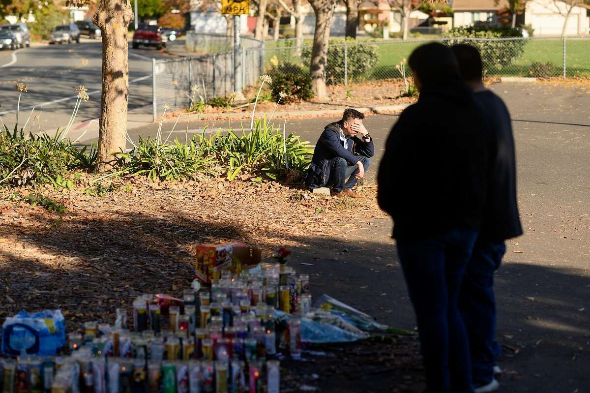 The father of a boy killed in the Searles Elementary School parking lot, who declined to give his name, mourns at the shooting site on Sunday, Nov. 24, 2019, in Union City, Calif. Authorities are searching for suspects in the fatal shooting of two boys, age 11 and 14, early Saturday morning.