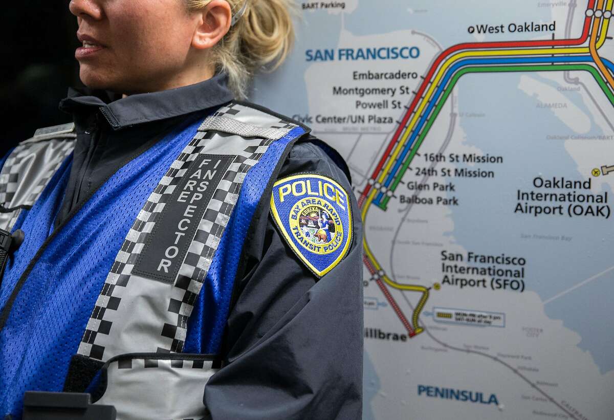 A Bart fare inspector leans against a transit map while patrolling a Daly City bound train during the morning commute in San Francisco, Calif. Thursday, May 31, 2018.