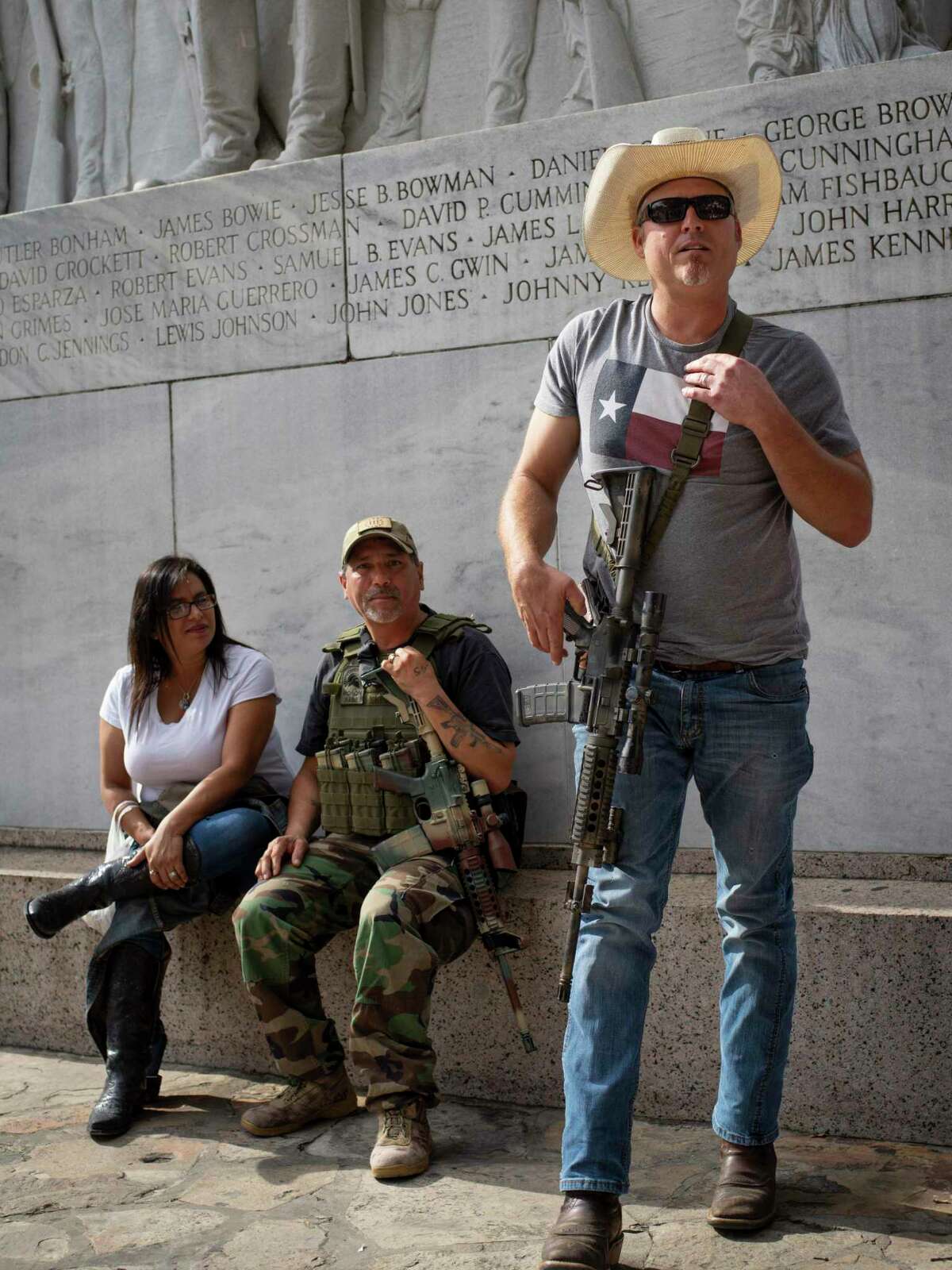 Corey Harris, right, and Carlos Soliz, center, participate in an occupation of the Alamo Cenotaph carrying rifles in an attempt to stop to the city of San Antonio from moving the historical monument on Friday, December 27, 2019. Members of This is Texas Freedom Force are opposing the planned moving of the Alamo Cenotaph by the city of San Antonio. ?’We?•re here today to occupy around the Cenotaph to stop any plans moving forward, trying to disassemble it and move it,?“ Brandon Burkhart, president of This is Texas Freedom Force (TITFF) said. TITFF is asking that Texas citizens be allowed to vote on the removal of the monument to the Battle of the Alamo and to those soldiers who died there, citing that the cost of movement and repair if it is damaged will cost Texas taxpayers.