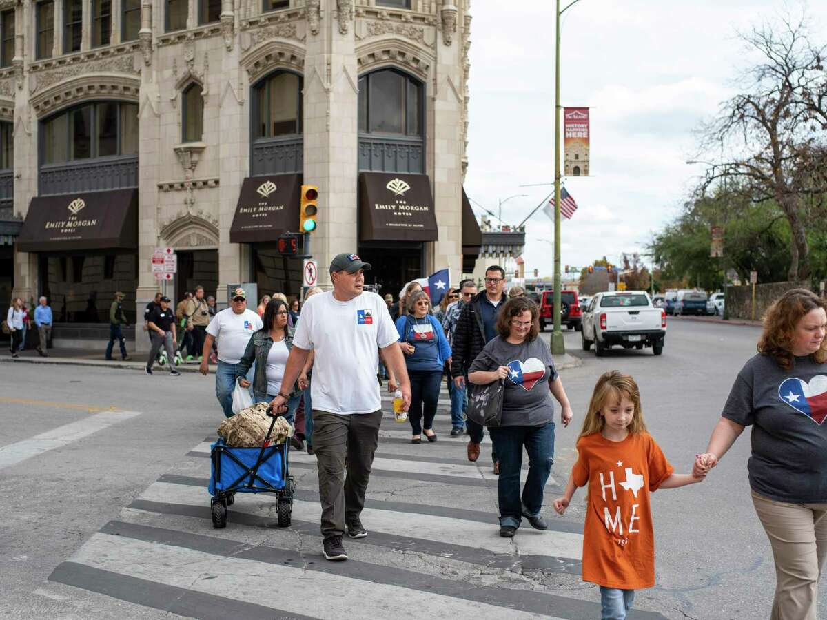 Brandon Burkhart, center left with white T-shirt, president of This is Texas Freedom Force, leads a group of protestors to occupy the space surrounding the Alamo Cenotaph in San Antonio, Texas, on Friday, December 27, 2019. Members of This is Texas Freedom Force are opposing the planned moving of the Alamo Cenotaph by the city of San Antonio. ?’We?•re here today to occupy around the Cenotaph to stop any plans moving forward, trying to disassemble it and move it,?“ Brandon Burkhart, president of This is Texas Freedom Force (TITFF) said. TITFF is asking that Texas citizens be allowed to vote on the removal of the monument to the Battle of the Alamo and to those soldiers who died there, citing that the cost of movement and repair if it is damaged will cost Texas taxpayers.