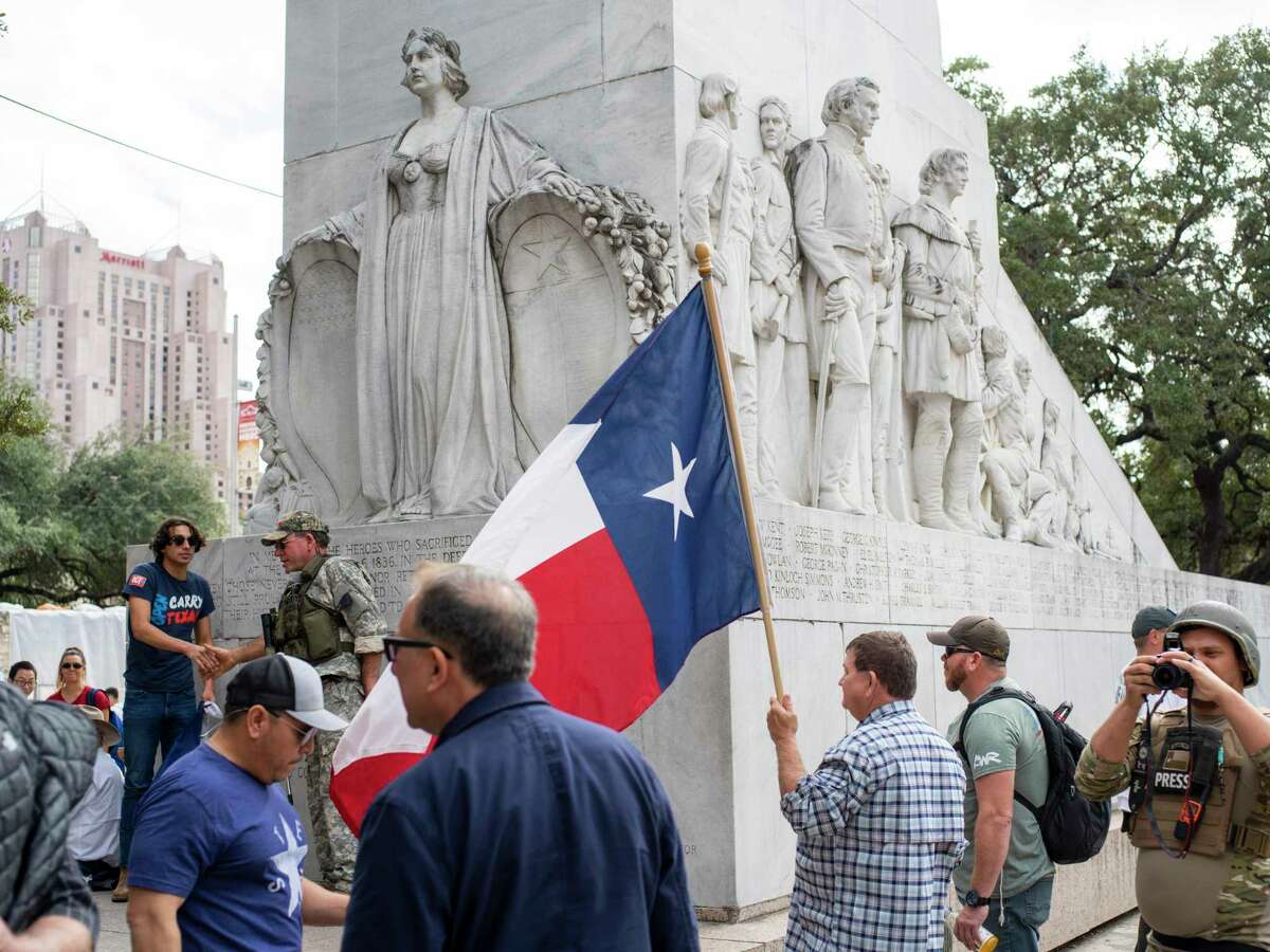 Members of the This is Texas Freedom Force and other supporters stage an Dec. 27 occupation of the Alamo Cenotaph to stop any movement of the monument by the city. The group and others have for years fought a proposed relocation of the memorial honoring the Texian and Tejano defenders of the fort who were killed in the famed 1836 battle.