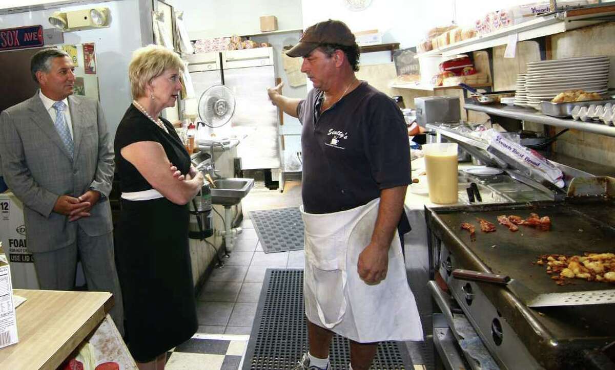 Republican senatorial candidate Linda McMahon spent some time touring small businesses in North Haven, Conn. on Wednesday August 11, 2010. Here, McMahon listens to Scotty Vincent, owner of Scotty the Omelet King restaurant along Broadway in the town. At left is State Senator Len Fasano (R-34) also visits with McMahon.