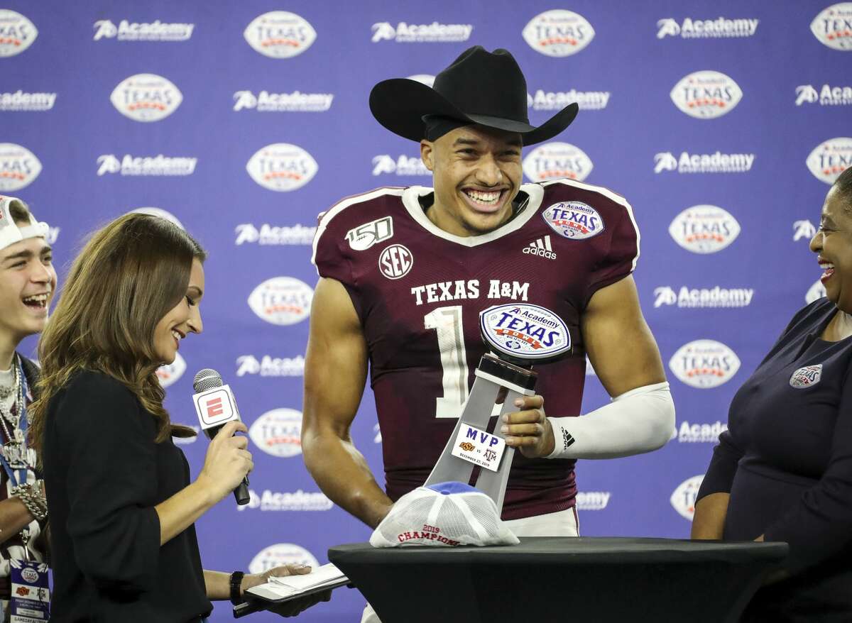 Texas A&M Aggies quarterback Kellen Mond (11) laughs on stage after the Texas A&M Aggies beat the Oklahoma State Cowboys in the Texas Bowl at NRG Stadium on Friday, Dec. 27, 2019, in Houston.