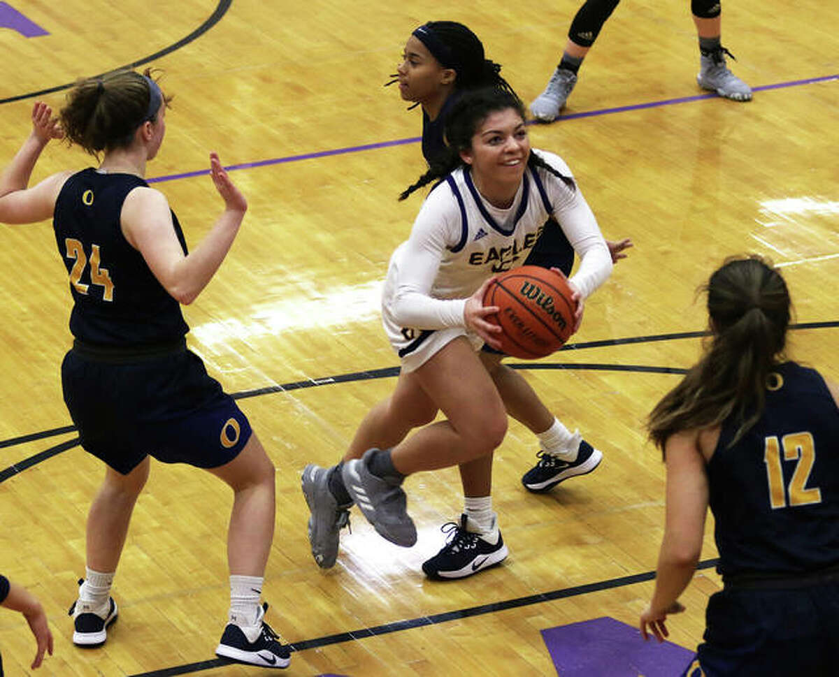CM’s Kourtland Tyus (middle) splits the O’Fallon defense to put up a shot in the lane during an Eagles’ won at the CM/Adidas Shootout on Dec. 20 in Bethalto. Tyus scored 21 points Friday night to go over 1,000 for her career.