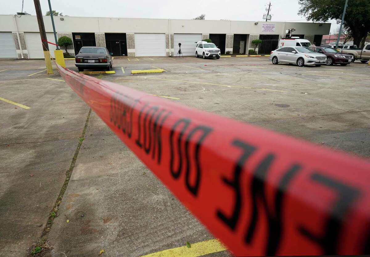 Police crime scene tape is shown in a parking lot Saturday, Dec. 28, 2019, in Houston in the 8500 block Sweetwater Lane where two people were shot and killed and at least seven others injured in a drive-by shooting while they were filming a music video Friday night.