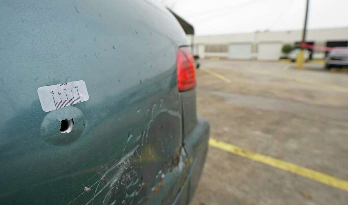 A bullet hole in a car is shown in a parking lot Saturday, Dec. 28, 2019, in Houston in the 8500 block Sweetwater Lane where two people were shot and killed and at least seven others injured in a drive-by shooting while they were filming a music video Friday night.