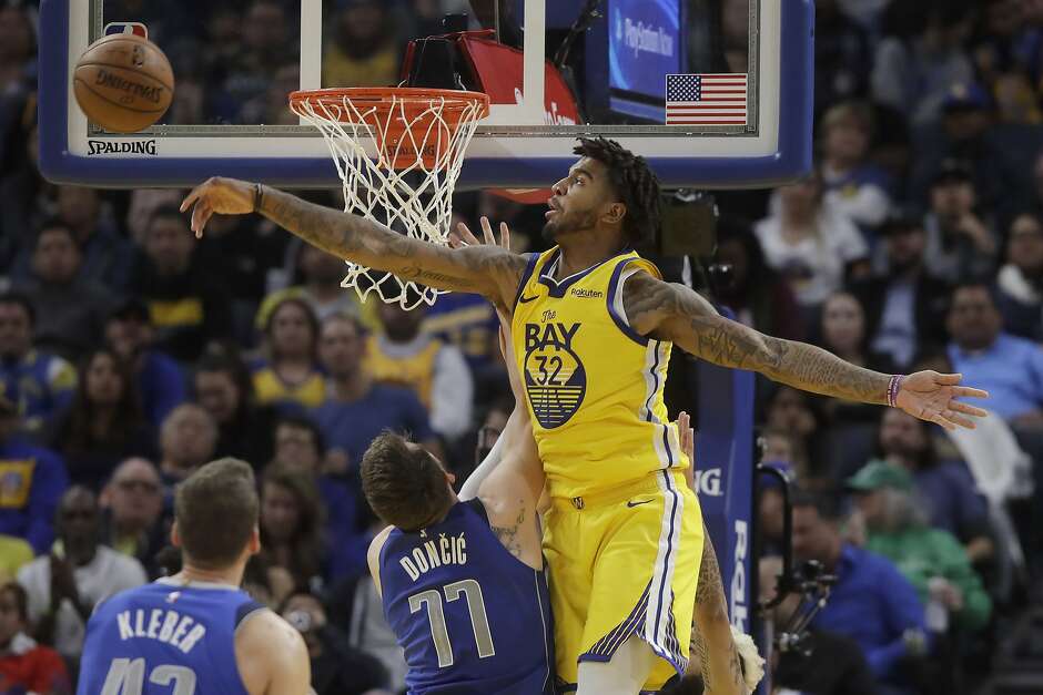 Golden State Warriors forward Marquese Chriss (32) blocks a shot by Dallas Mavericks forward Luka Doncic (77) during the second half of an NBA basketball game in San Francisco, Saturday, Dec. 28, 2019. (AP Photo/Jeff Chiu)