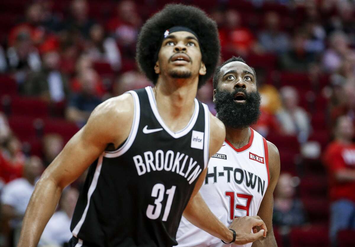 Houston Rockets guard James Harden (13) and Brooklyn Nets center Jarrett Allen (31) watch a free throw during the fourth quarter of an NBA game at the Toyota Center on Saturday, Dec. 28, 2019, in Houston.