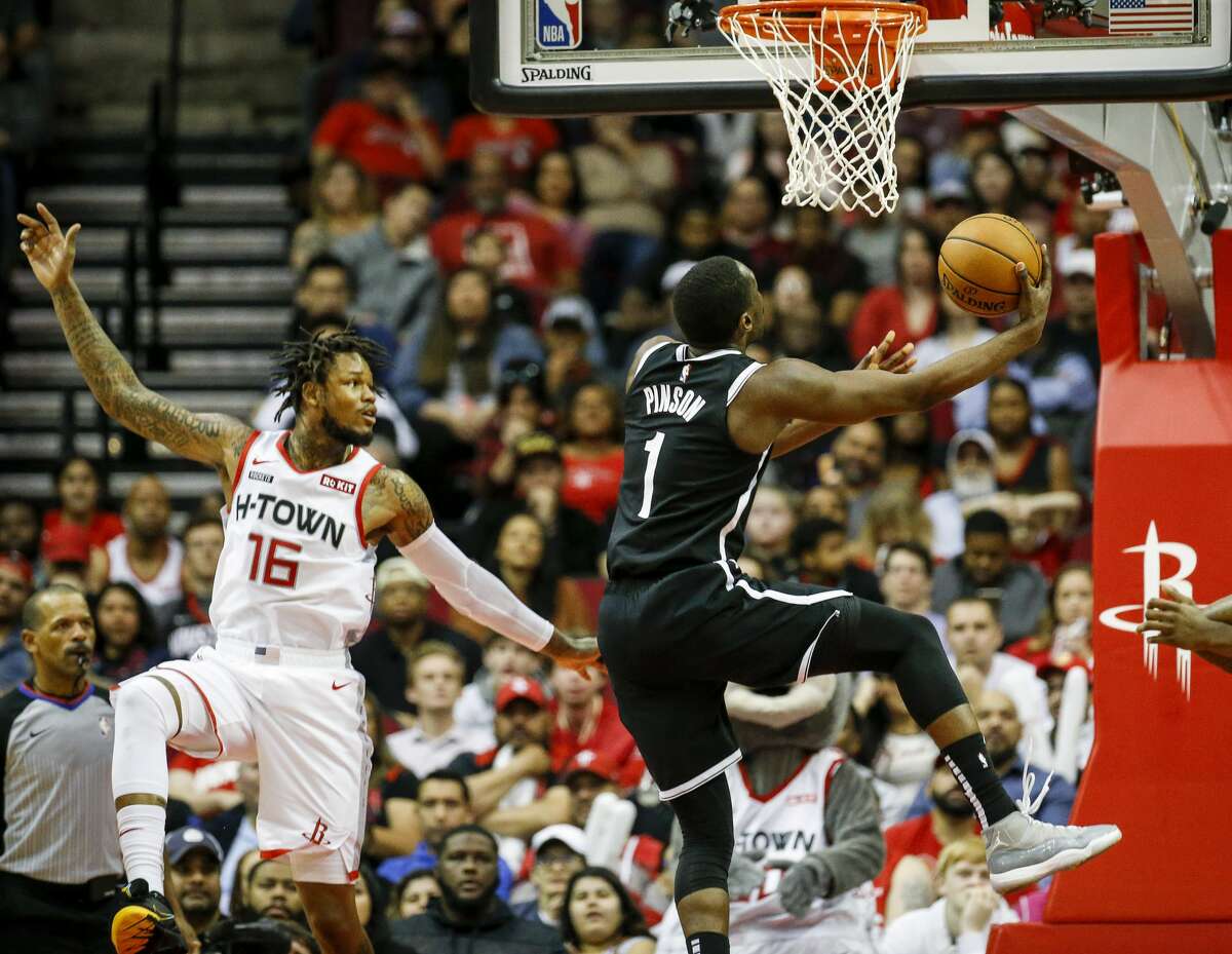 Brooklyn Nets guard Theo Pinson (1) drives to the basket past Houston Rockets guard Ben McLemore (16) during the fourth quarter of an NBA game at the Toyota Center on Saturday, Dec. 28, 2019, in Houston.
