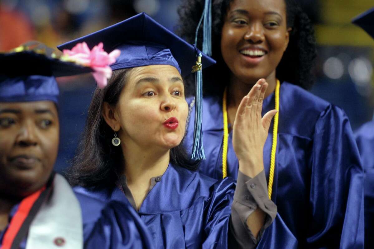 Marta Villegras, of Fairfield, blows a kiss towards the crowd while entering Commencement for the Housatonic Community College Class of 2019, held at Webster Bank Arena in Bridgeport, Conn. May 22. 2019.