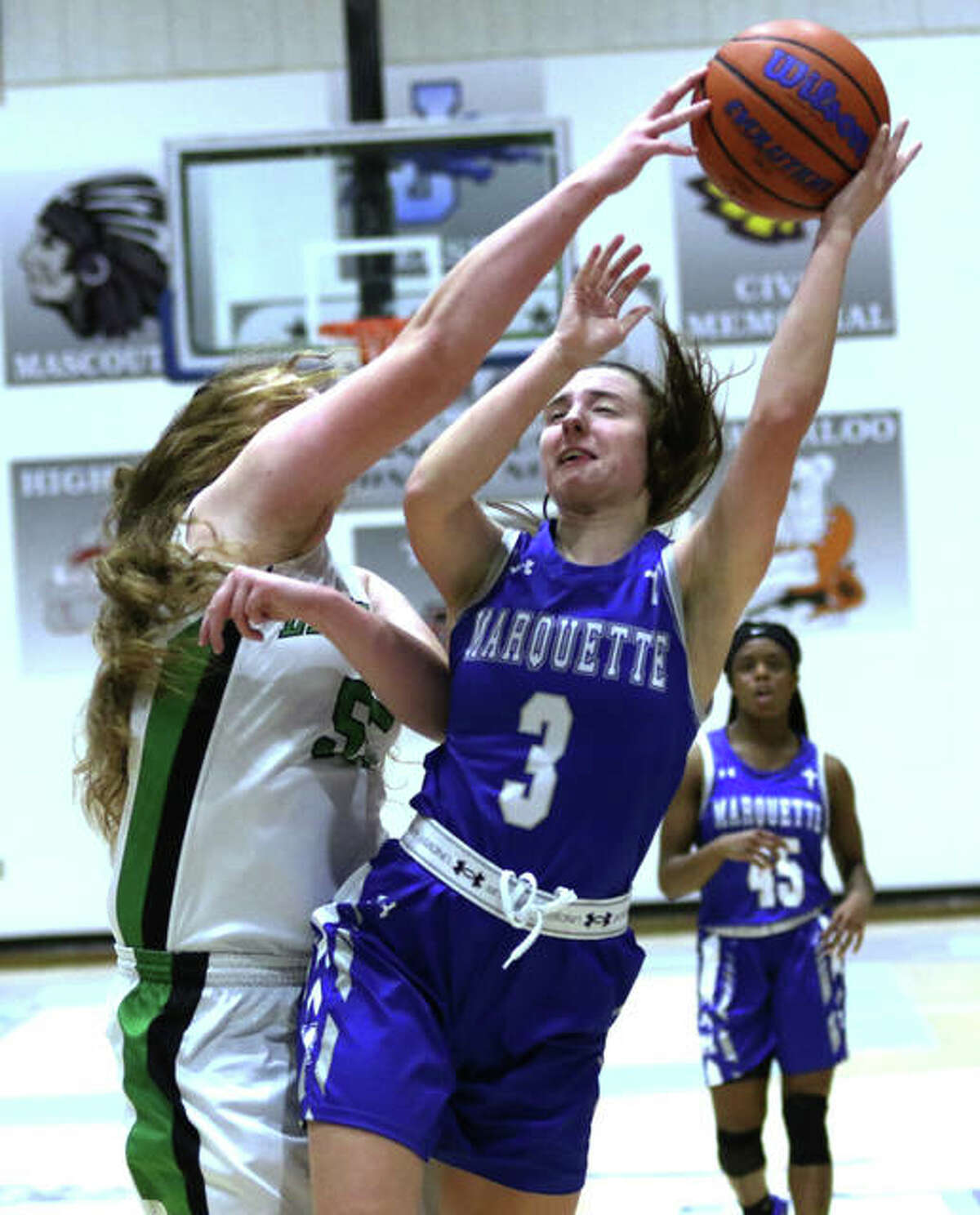 Marquette’ Kamryn Fandrew (3) is fouled by Carrollton’s Ava Uhles on a fast-break Friday at the Jersey Tourney.