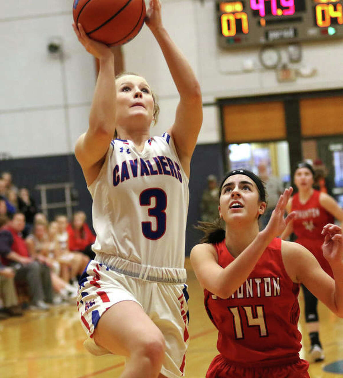Carlinville’s Eryn Seals (3) goes in for a layup ahead of Staunton’s Katie Masinelli on a break Thursday at the Carlinville Holiday Tourney.