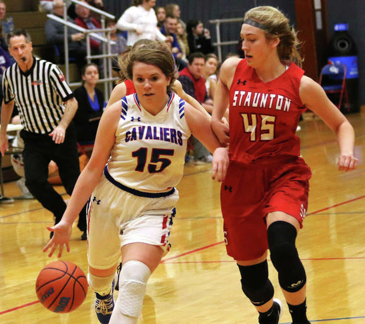 Carlinville’s Gracie Reels (15), shown taking the ball to the basket against Staunton’s Haris Legendre on Thursday, scored 18 points Saturday in the Cavs’ victory over Litchfield at the Carlinville Holiday Tourney.