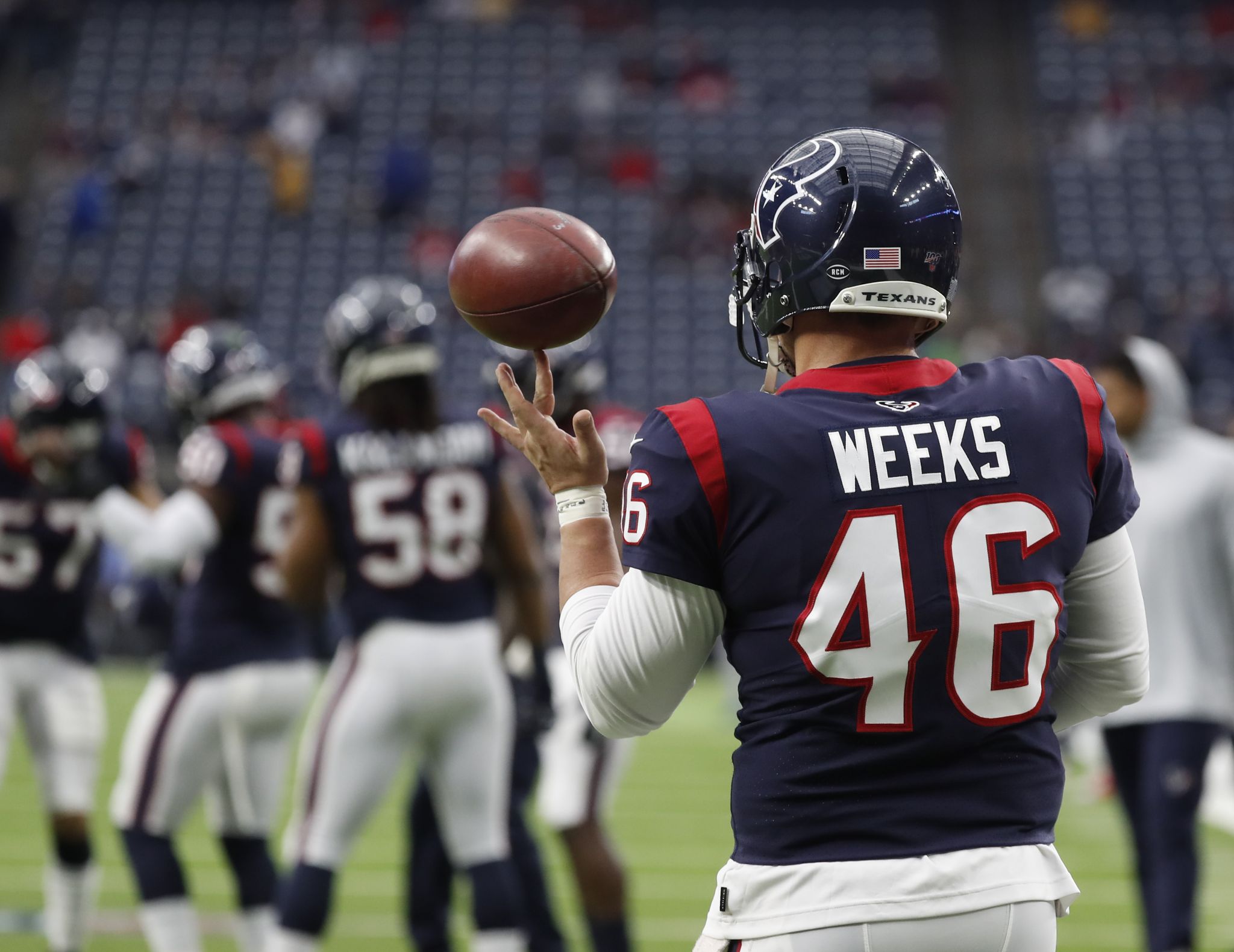 Houston Texans head coach Bill O'Brien talks on his head set next to  running back Carlos Hyde (23) during the second half of an NFL football  game against the Kansas City Chiefs