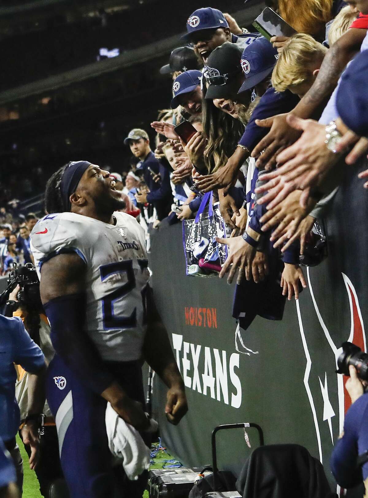 Tennessee Titans running back Derrick Henry (22) celebrates with Titans fans after beating the Houston Texans 35-14 in an NFL football game at NRG Stadium on Sunday, Dec. 29, 2019, in Houston.