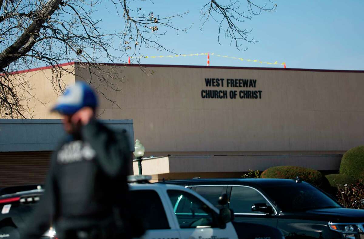 An officer walks near the scene after a church shooting at West Freeway Church of Christ on Sunday, Dec. 29, 2019 in White Settlement, Texas. (Juan Figueroa/The Dallas Morning News via AP)