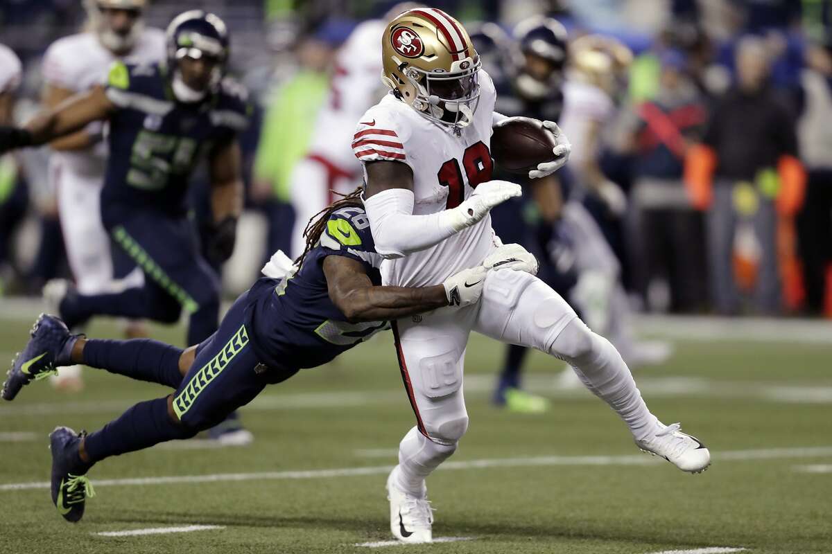San Francisco 49ers' Deebo Samuel (19) carries the ball as Seattle Seahawks' Shaquill Griffin tries to pull him down during the second half of an NFL football game, Sunday, Dec. 29, 2019, in Seattle. (AP Photo/Stephen Brashear)