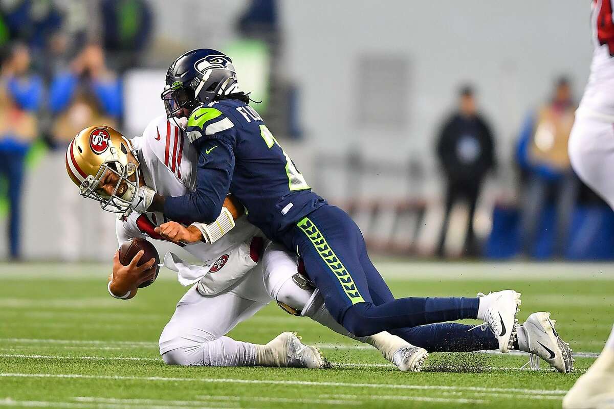 SEATTLE, WASHINGTON - DECEMBER 29: Tre Flowers #21 of the Seattle Seahawks sacks Jimmy Garoppolo #10 of the San Francisco 49ers during the first quarter of the game at CenturyLink Field on December 29, 2019 in Seattle, Washington. (Photo by Alika Jenner/Getty Images)