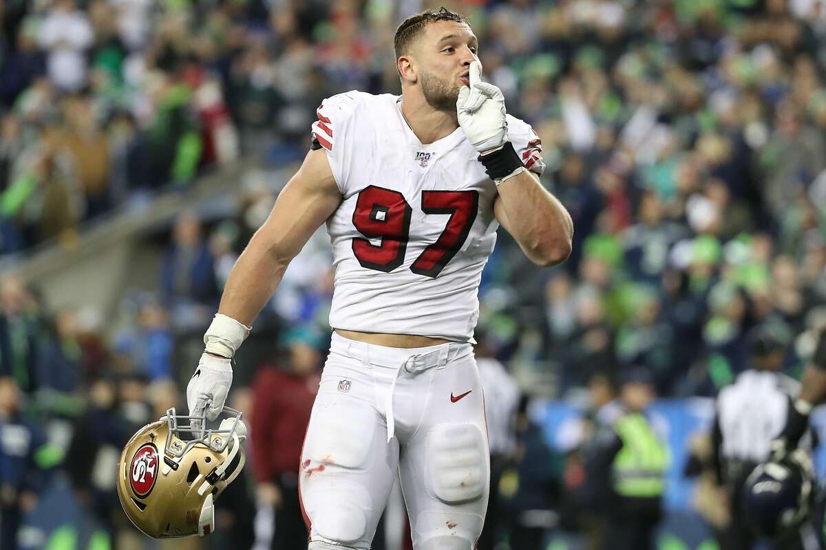 SEATTLE, WASHINGTON - DECEMBER 29: Nick Bosa #97 of the San Francisco 49ers silences the crowd after stopping the Seattle Seahawks on fourth down in the fourth quarter to defeat the Seattle Seahawks 26-21 during their game at CenturyLink Field on December 29, 2019 in Seattle, Washington. (Photo by Abbie Parr/Getty Images)