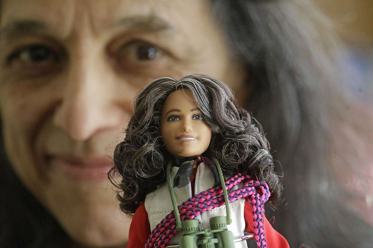 This Dec. 3, 2019, photo, ecologist Nalini Nadkarni is shown in her lab on the University of Utah campus in Salt Lake City holding a Barbie created to look like her when she's climbing into the treetops to study the rainforest canopy. Nadkarni's childhood climbing trees shaped her career and now she's hoping she can get help kids interested in science in an new way: Barbies. Nadkarni has long created her own "treetop Barbies" and has now helped Mattel and National Geographic create a line of dolls with careers in science and conservation. (AP Photo/Rick Bowmer)