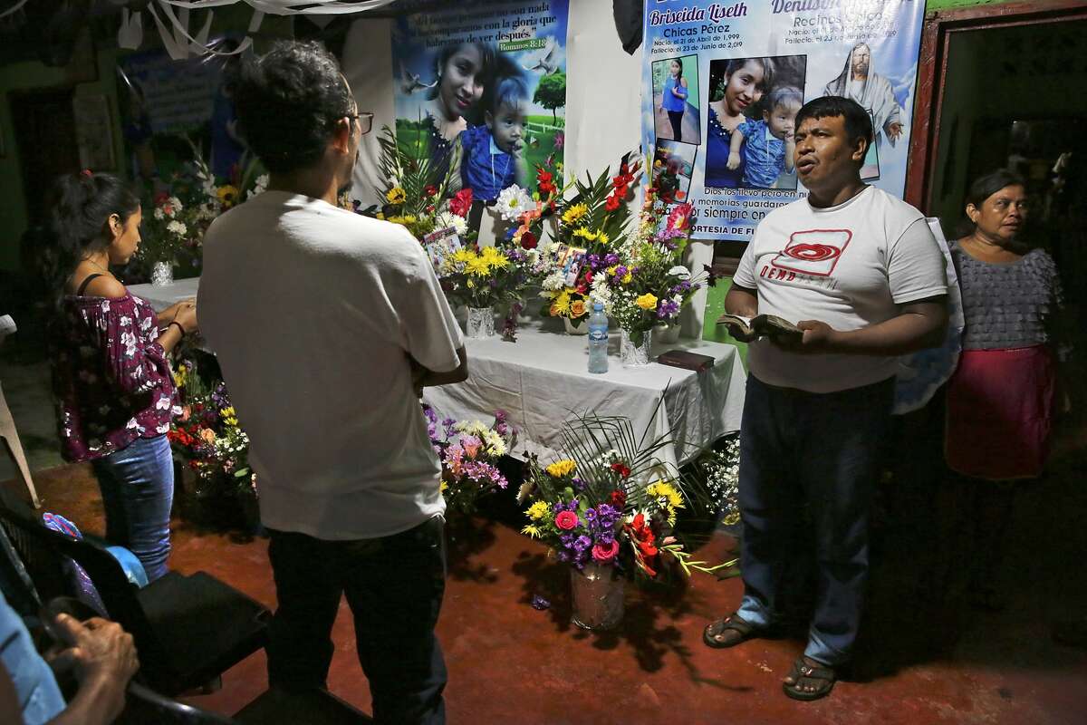 A Catholic layman Onofre Dioncio Paxtor leads a group in song in front of the shrine for Briseyda Lisseth Chicas Perez and her son Denilson, at the family's home in Chiquirines, Guatemala, on Sunday, June 30, 2019. Two other children from the nearby village of El Reparo who were traveling with Briseyda also died on the trip.