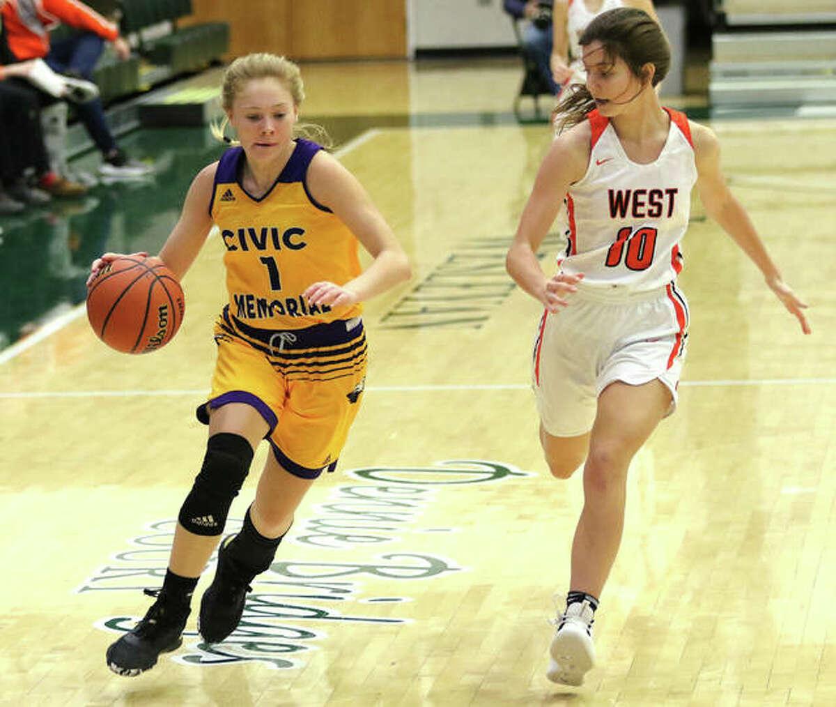 CM’s Tori Standefer (left) rushes the ball upcourt while Lincoln-Way West’s Lindsey O’Donnell defends on Monday in the third-place game at the State Farm Classic at Illinois Wesleyan’s Shirk Center in Bloomington.