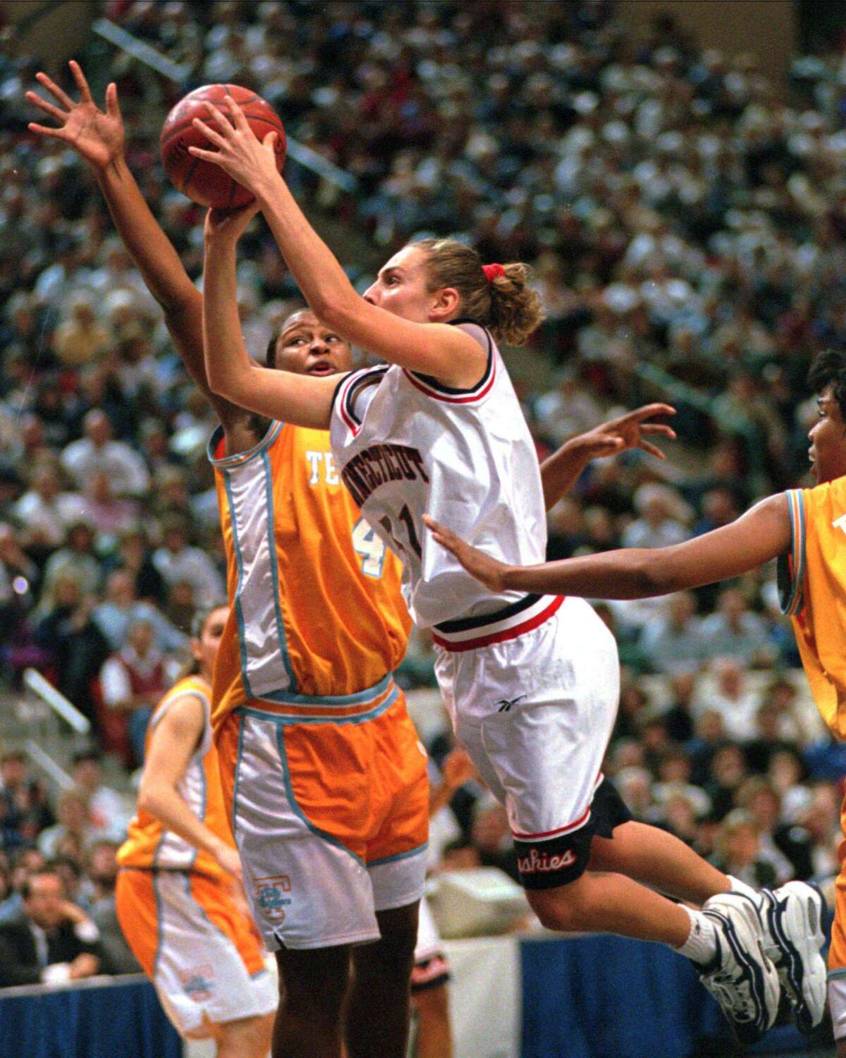 Former UConn player Carla Berube, center, shoots in front of Tennessee’s Tiffani Johnson in a 1996 game in Hartford.