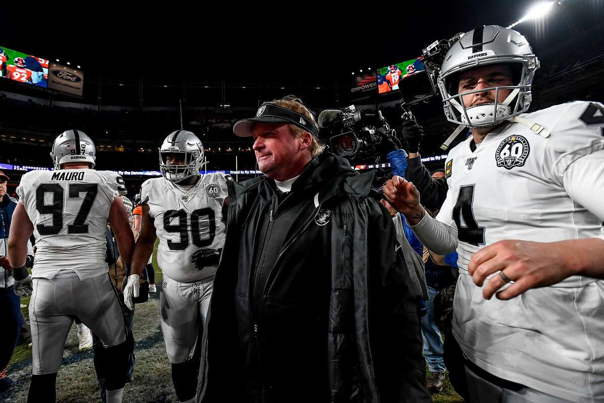 DENVER, CO - DECEMBER 29: Head coach Jon Gruden of the Oakland Raiders walks onto the field with Derek Carr #4 after a 16-15 loss to the Denver Broncos at Empower Field at Mile High on December 29, 2019 in Denver, Colorado. (Photo by Dustin Bradford/Getty Images)